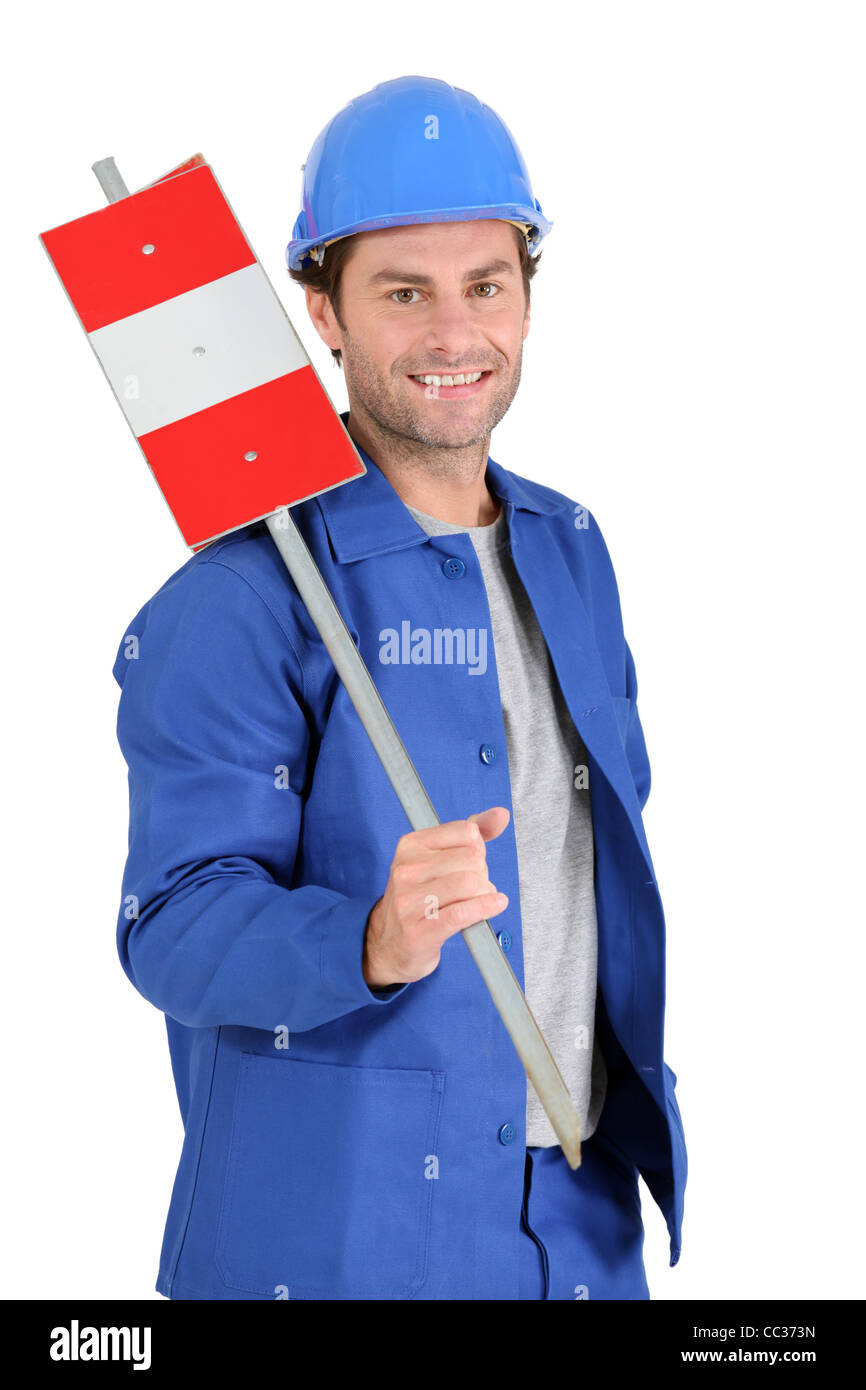 Builder holding road sign. Stock Photo