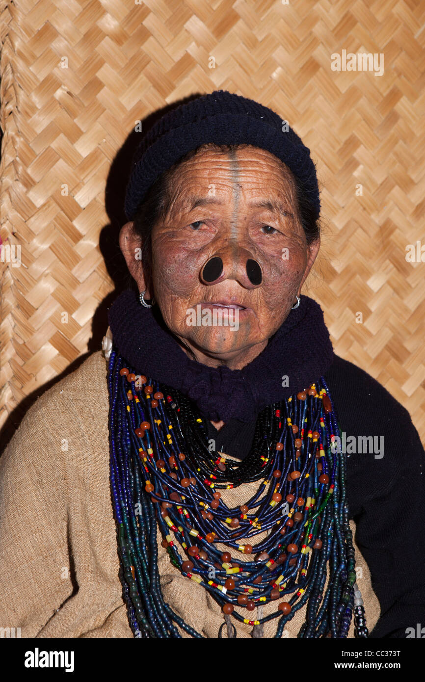 India, Arunachal Pradesh, Ziro Valley, Mida, face of older tattooed Apatani woman with facial tattoos and nose plugs Stock Photo