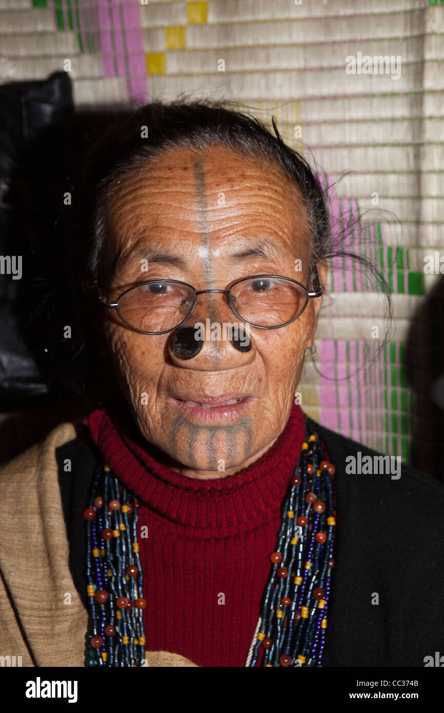 India, Arunachal Pradesh, Ziro Valley, Mida, face of older tattooed Apatani woman with facial tattoos and nose plugs Stock Photo