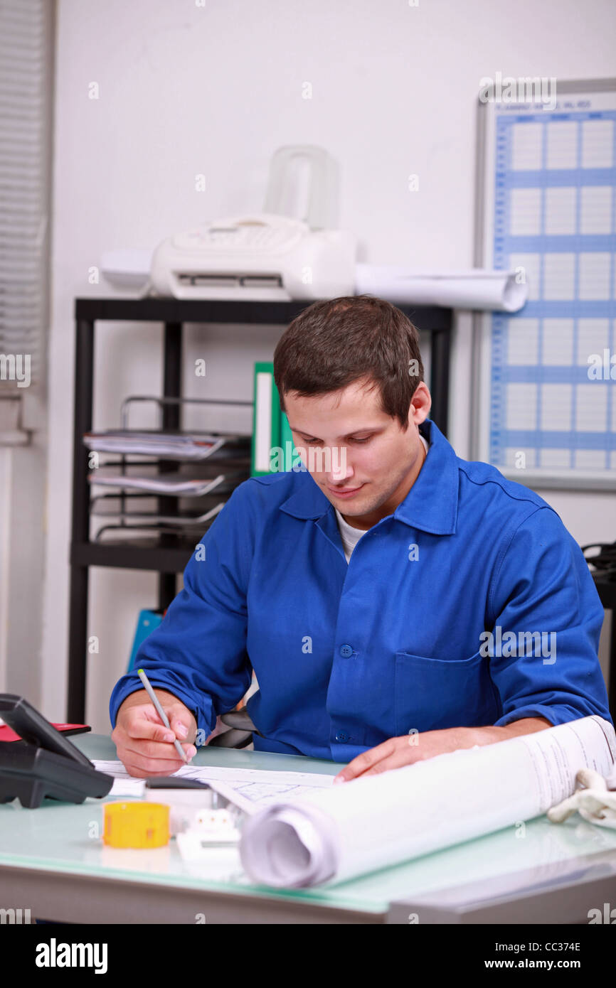 Worker Using Under Paper factory worker doing paper work in the office Stock Photo - Alamy