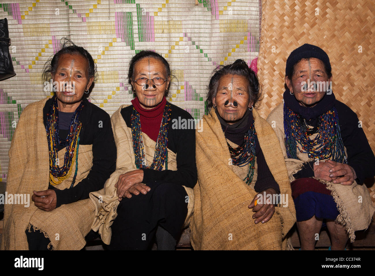 India, Arunachal Pradesh, Ziro Valley, Mida, four older tattooed Apatani women with facial tattoos and nose plugs Stock Photo