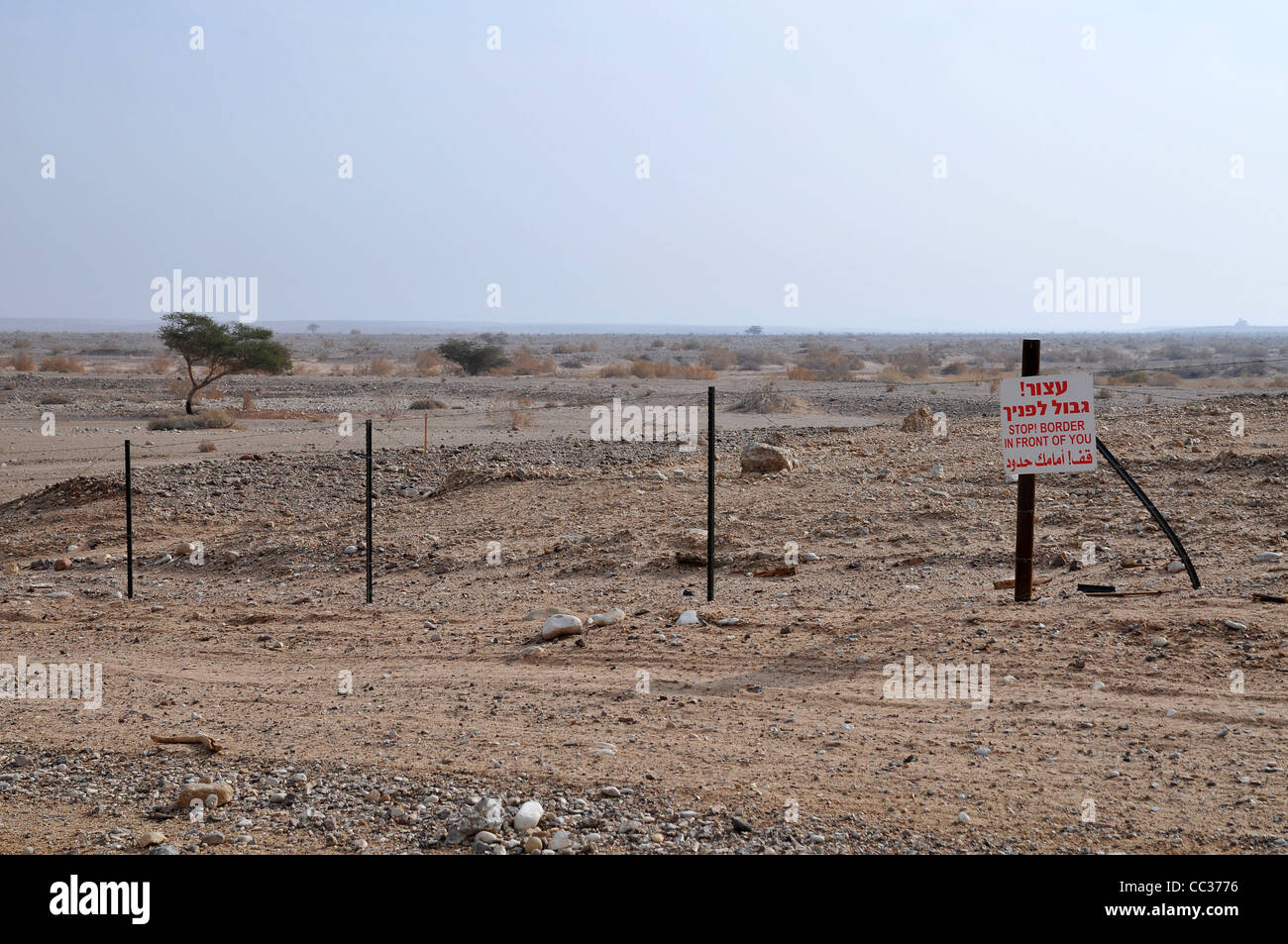 View of the fence and 'Danger Minds' marking the border between Israel and Jordan, Photo by Shay Levy Stock Photo