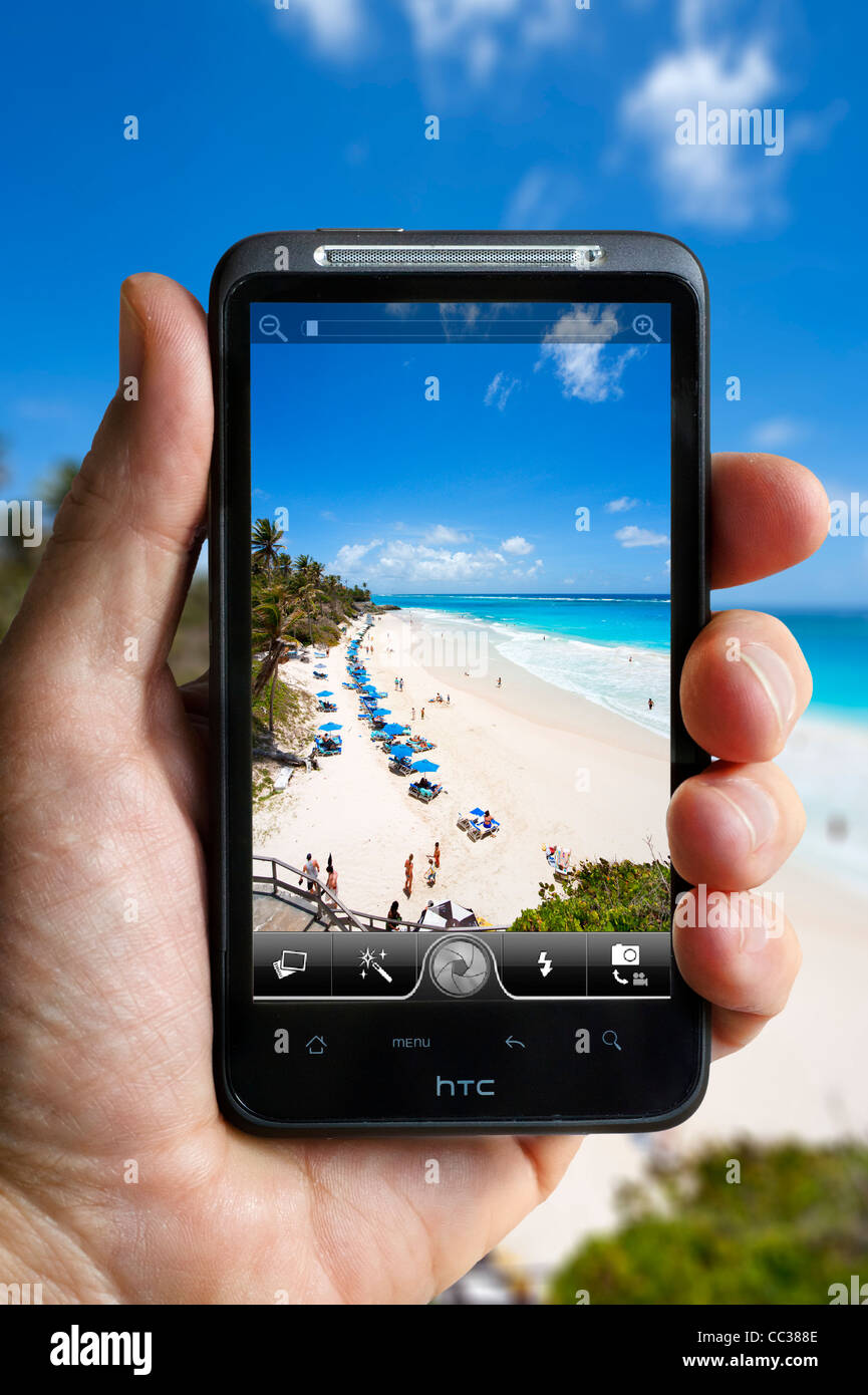 Taking a photograph of Crane beach in Barbados on an HTC smartphone Stock Photo