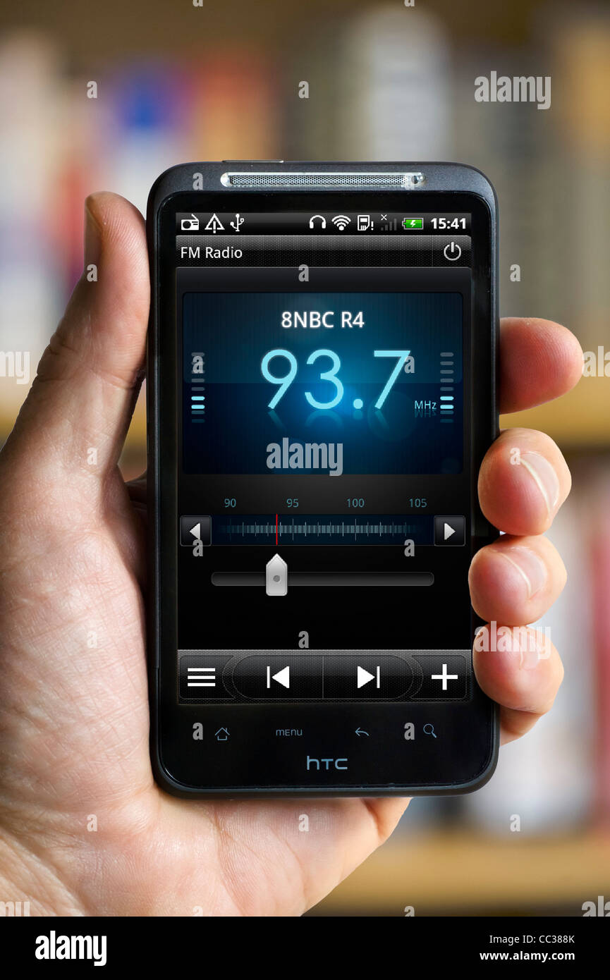Listening to FM Radio on an HTC smartphone Stock Photo