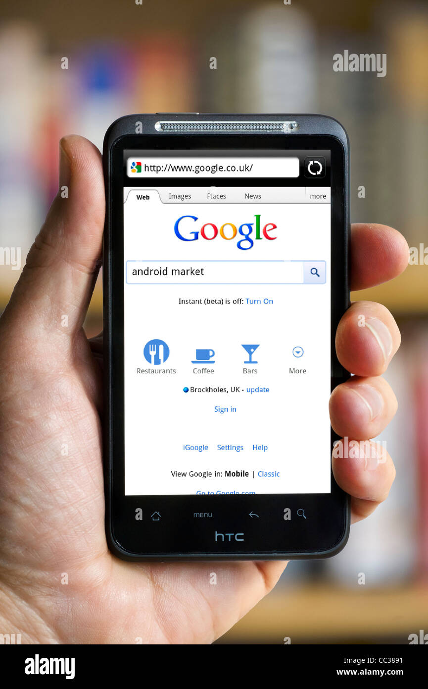Performing a Google search on an HTC smartphone Stock Photo
