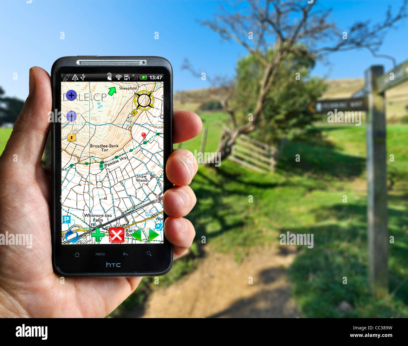 Using an Ordnance Survey App (OS Atlas) on an HTC smartphone on the Pennine Way near Edale, Peak District, Derbyshire, UK Stock Photo