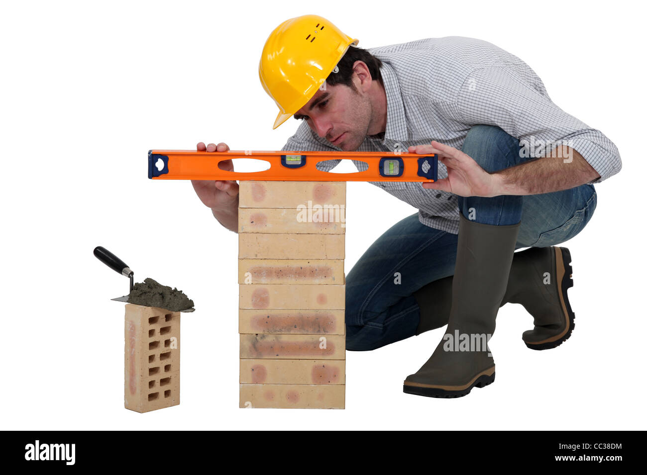 Tradesman using a spirit level Stock Photo - Alamy