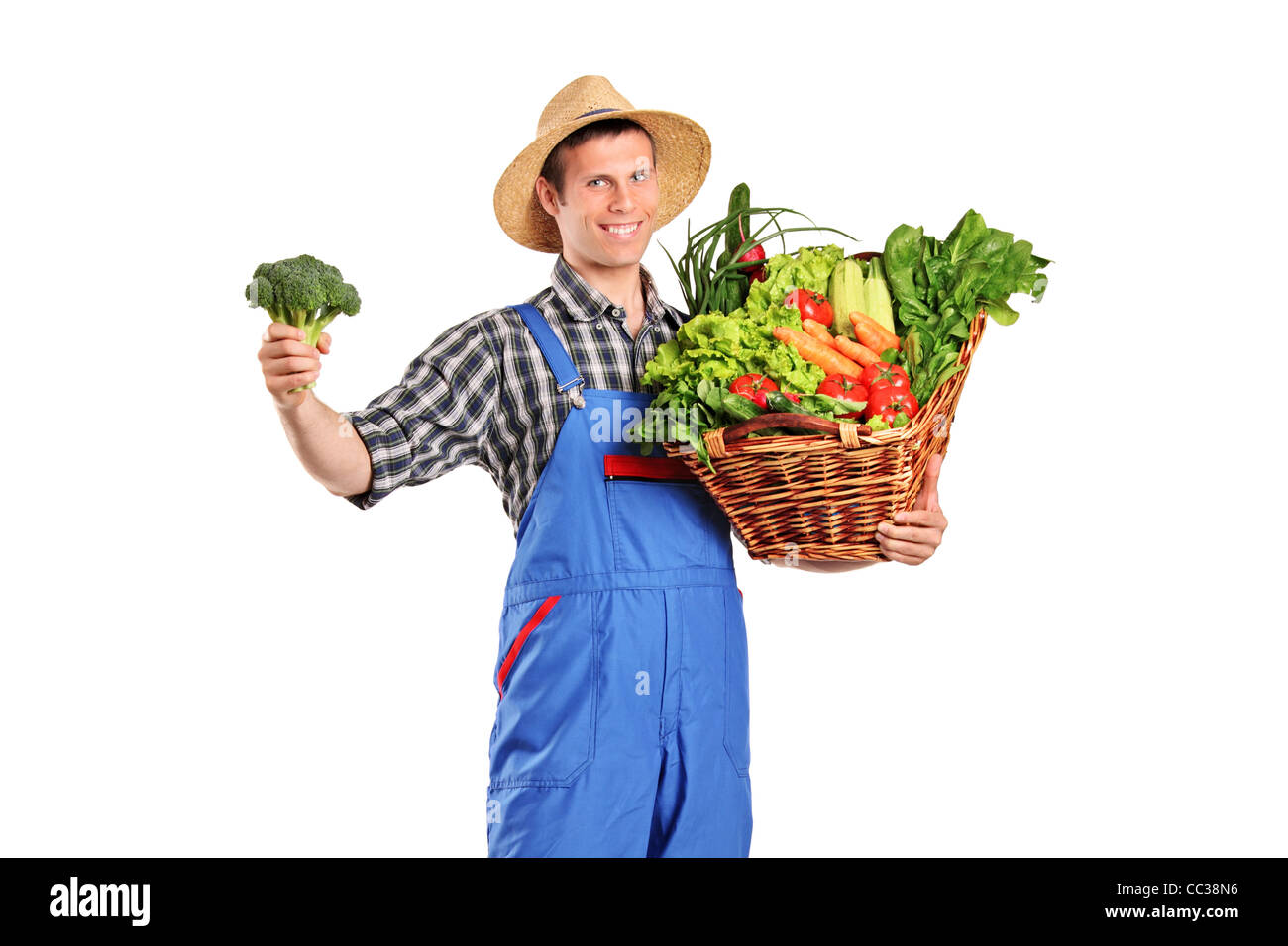A male farmer holding a basket full of vegetables Stock Photo - Alamy