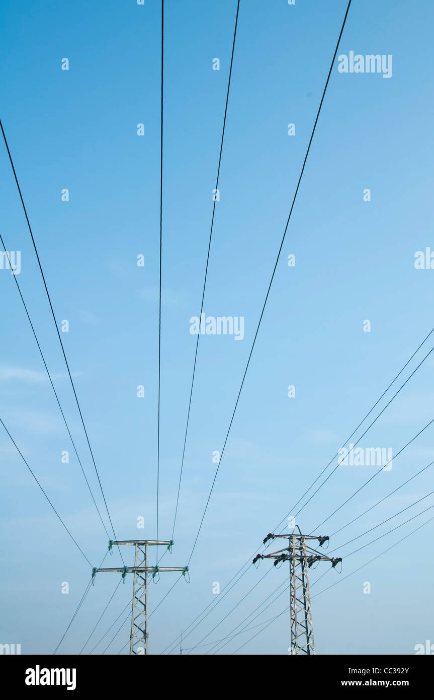 High voltage poles and wires on blue sky Stock Photo - Alamy