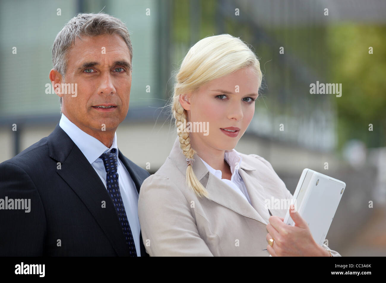 Business couple standing outside Stock Photo - Alamy