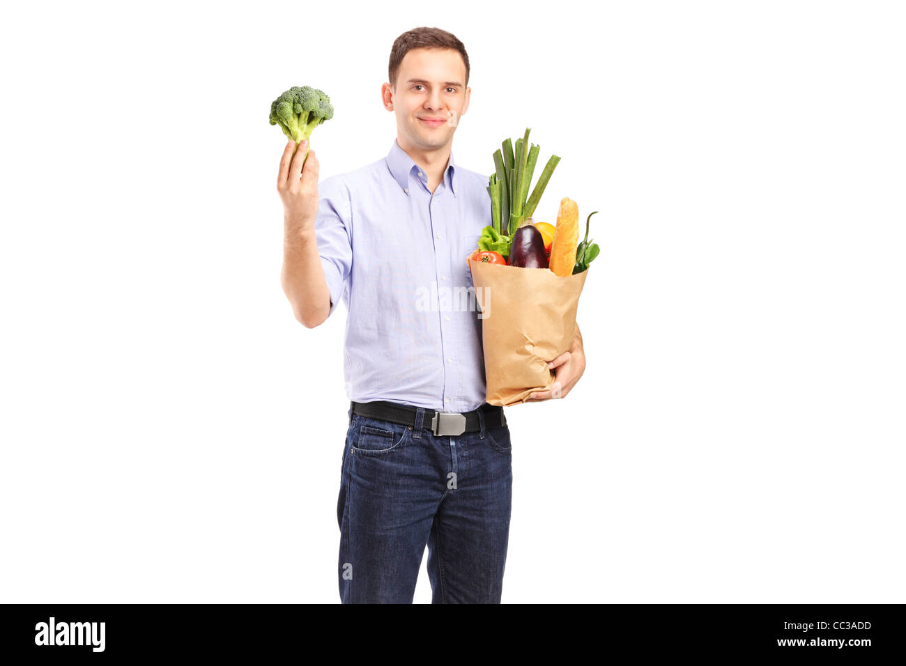 A young man holding a shopping bag with products and a broccoli in his hand  Stock Photo - Alamy