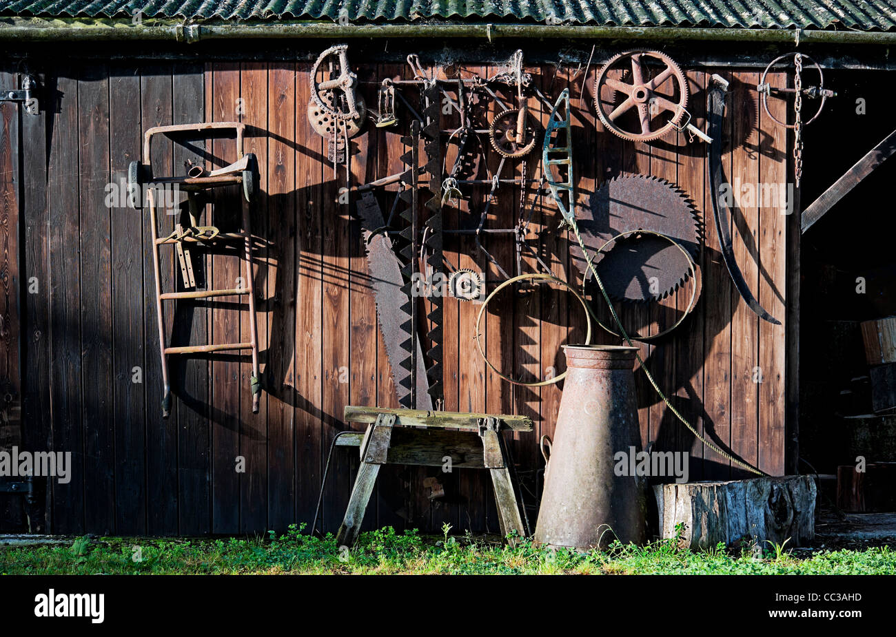 Wooden shed with rusty old tools in side lighting Stock Photo