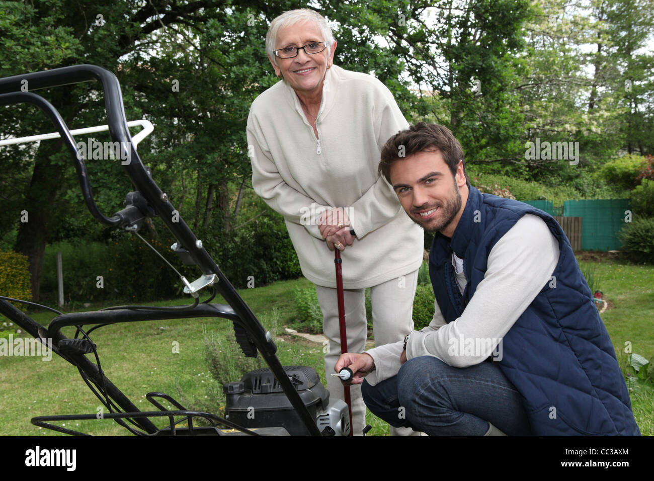 Son helping Mother in the garden Stock Photo - Alamy