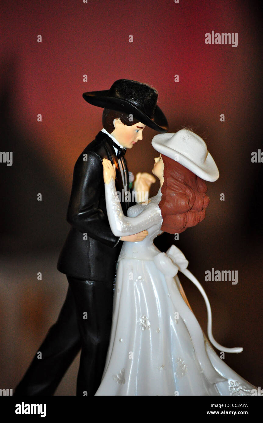 A Wedding Cake Topper With A Country And Western Style Sits On Top