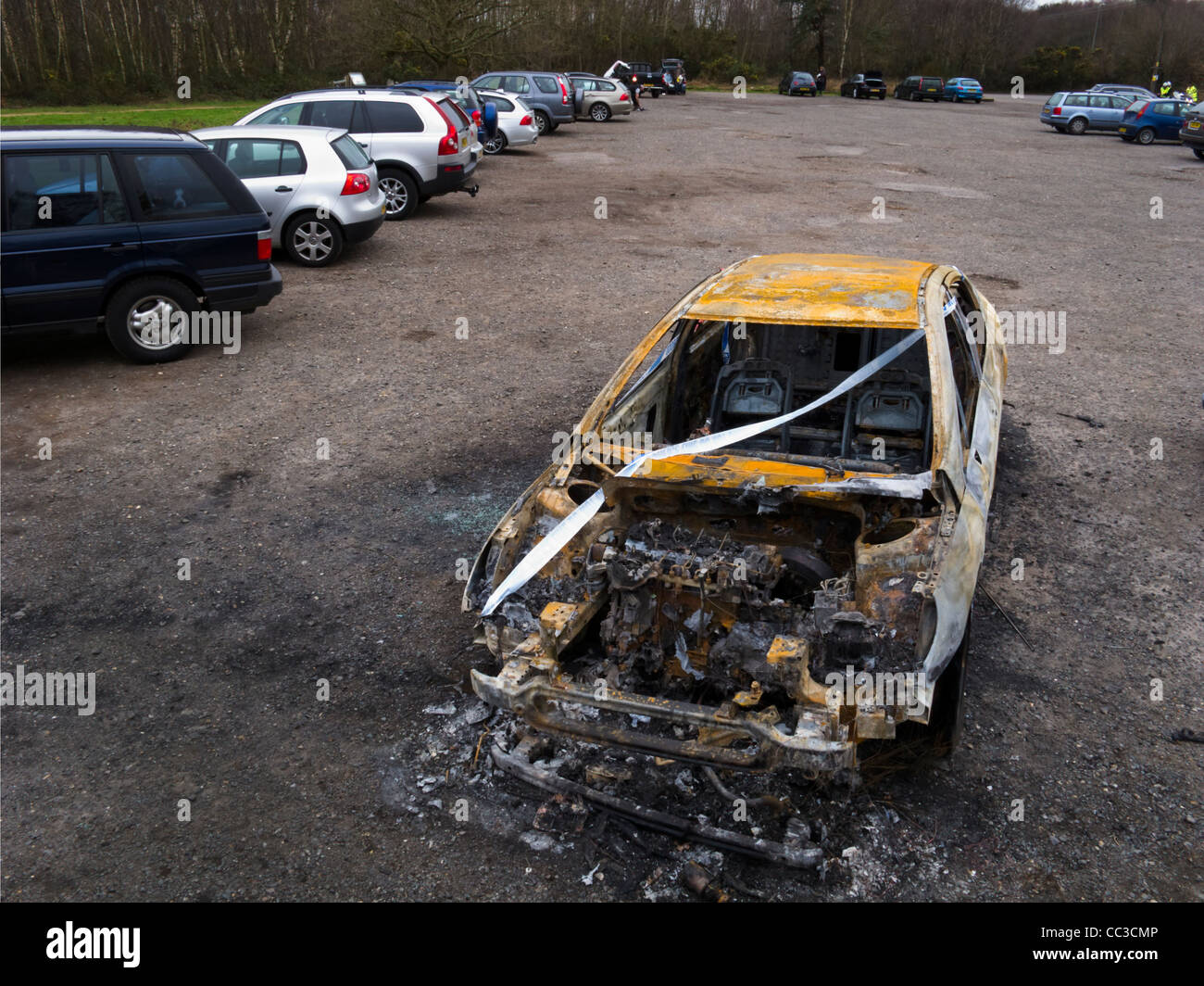 Burnt out car in a car park on Chobham Common, Surrey, UK Stock Photo