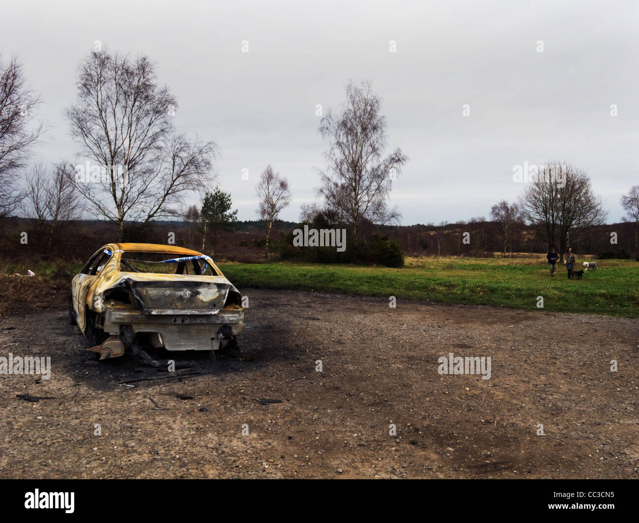 Burnt out car in a car park on Chobham Common, Surrey, UK Stock Photo