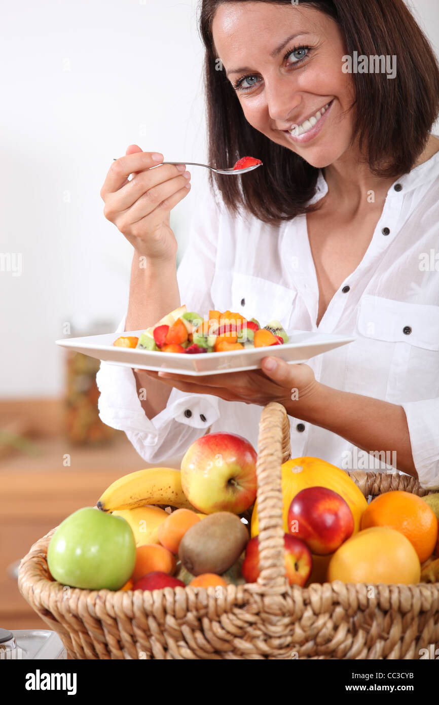 Woman eating a fruit salad Stock Photo Alamy