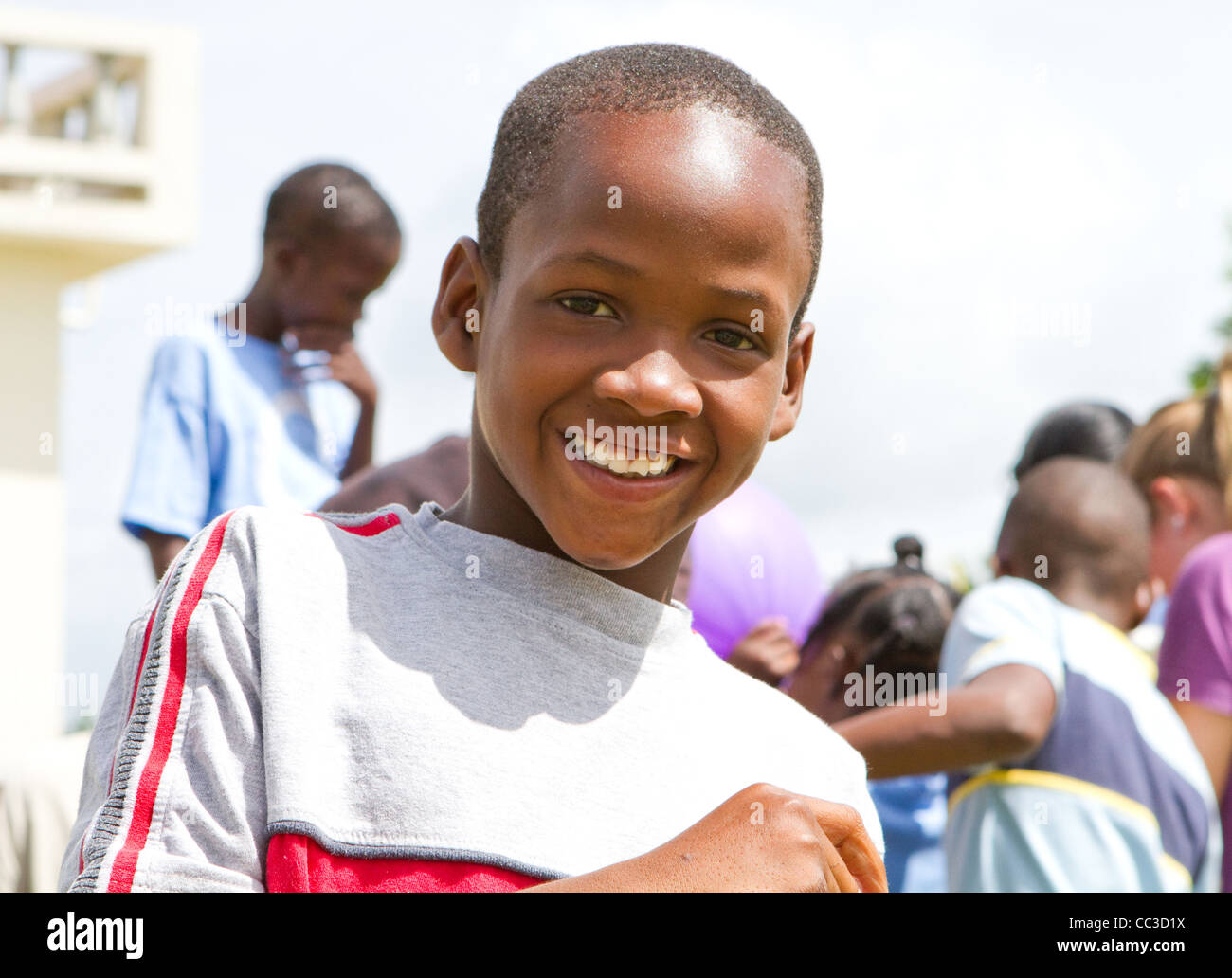 Jamaican orphan boy with broken front teeth smiling. Stock Photo