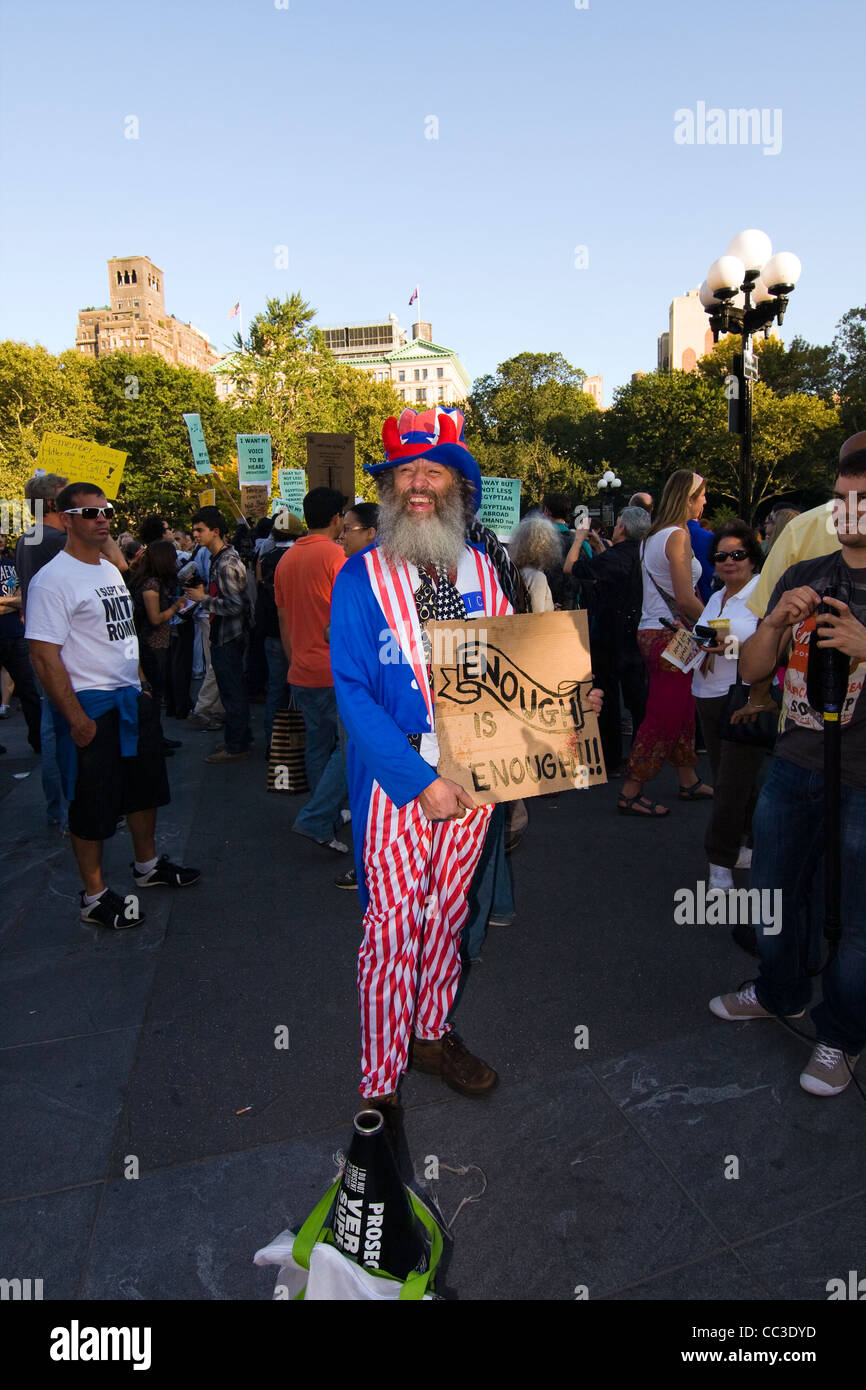 Political Activist and Performance Artist named Vermin Supreme holding a protest sign in Washington Sq. Park in New York City Stock Photo