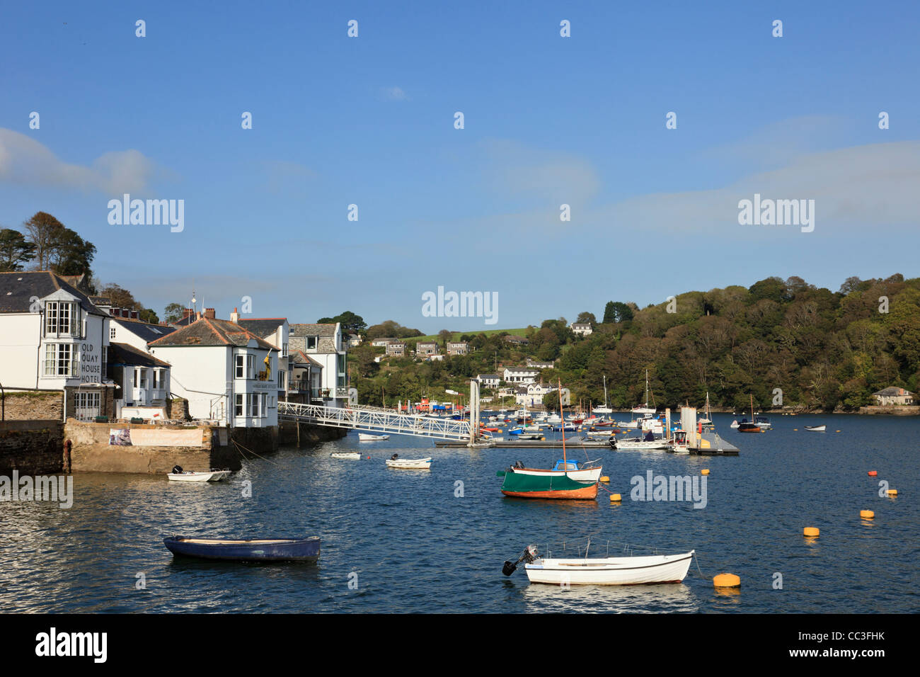 View to waterfront buildings on the quay and moored boats on the Fowey River in Fowey, Cornwall, England, UK, Britain Stock Photo