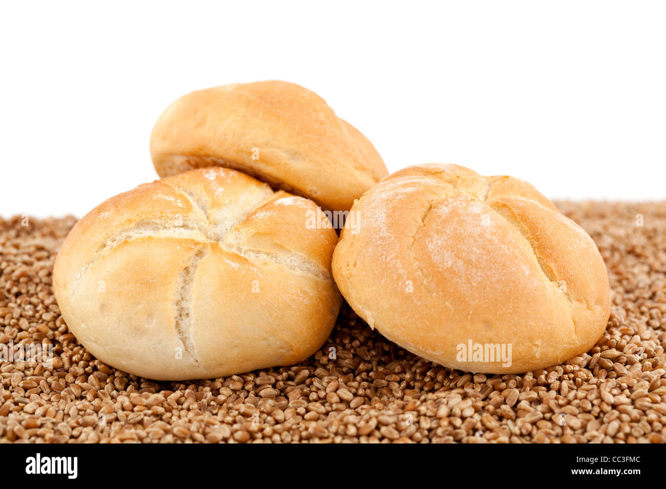 crunchy fresh bun on wheat on white background Stock Photo