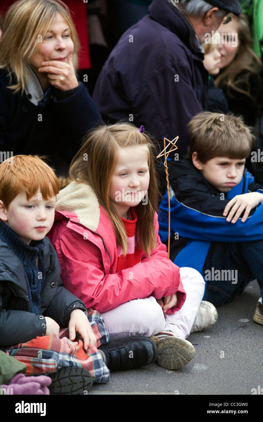 Audience members watch a performance of traditional theatre celebrating a 'wassail' to herald the new year. Stock Photo