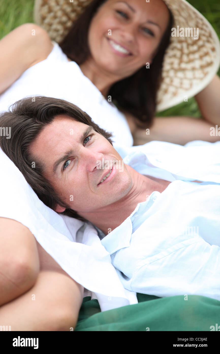 Couple relaxing in the park on a summers day Stock Photo - Alamy
