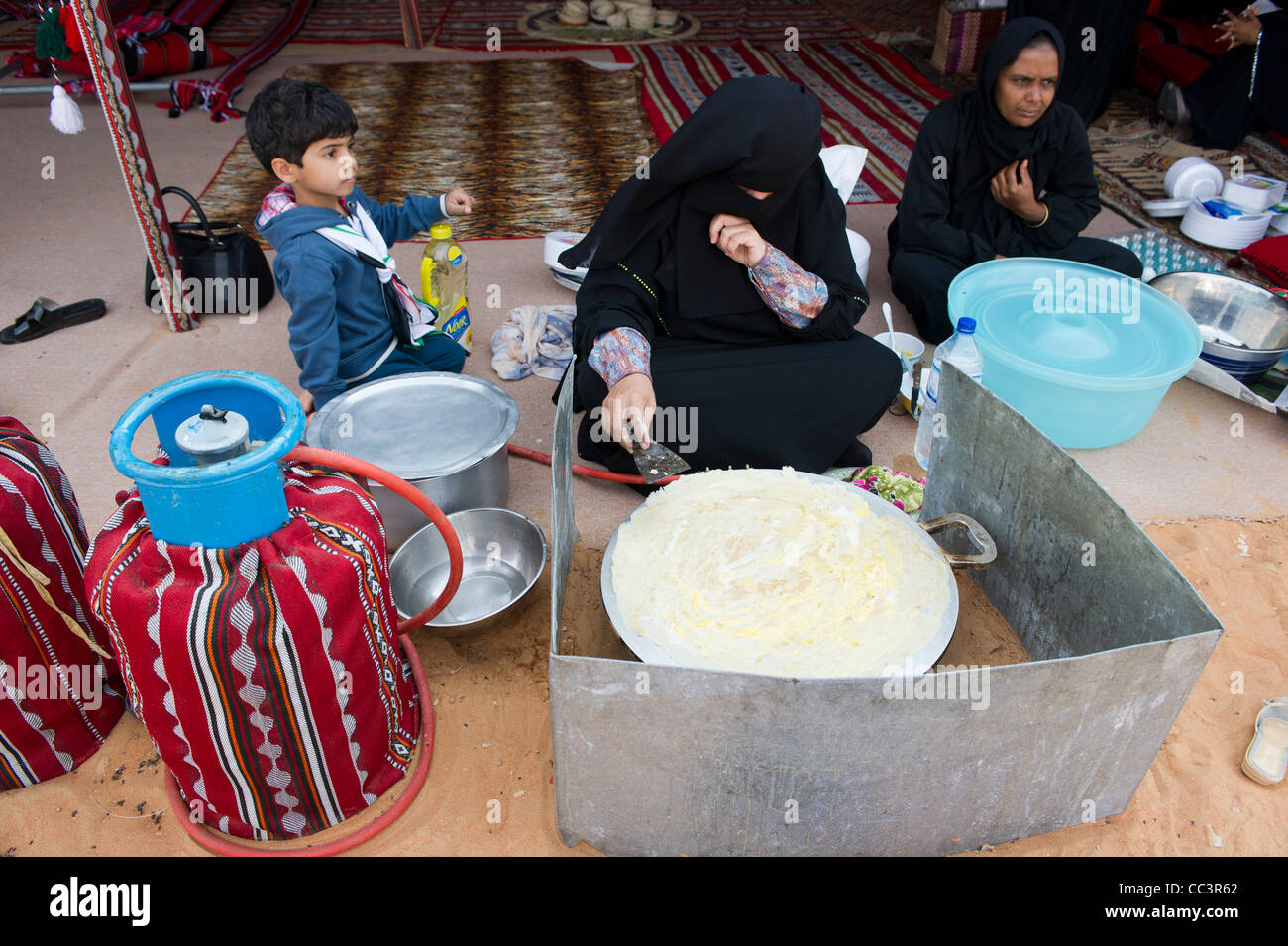 Local women cooking bread. Abu Dhabi. United Arab Emirates. 5/1/2012 Stock Photo