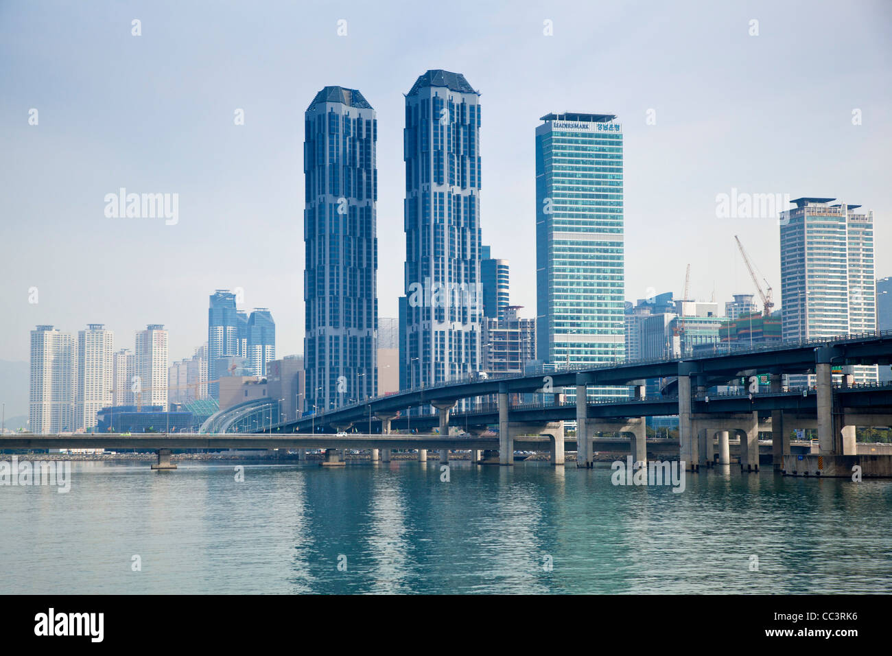 Korea, Gyeongsangnam-do, Busan, Haeundae luxury appartment buildings reflecting in Suyeonggang River Stock Photo