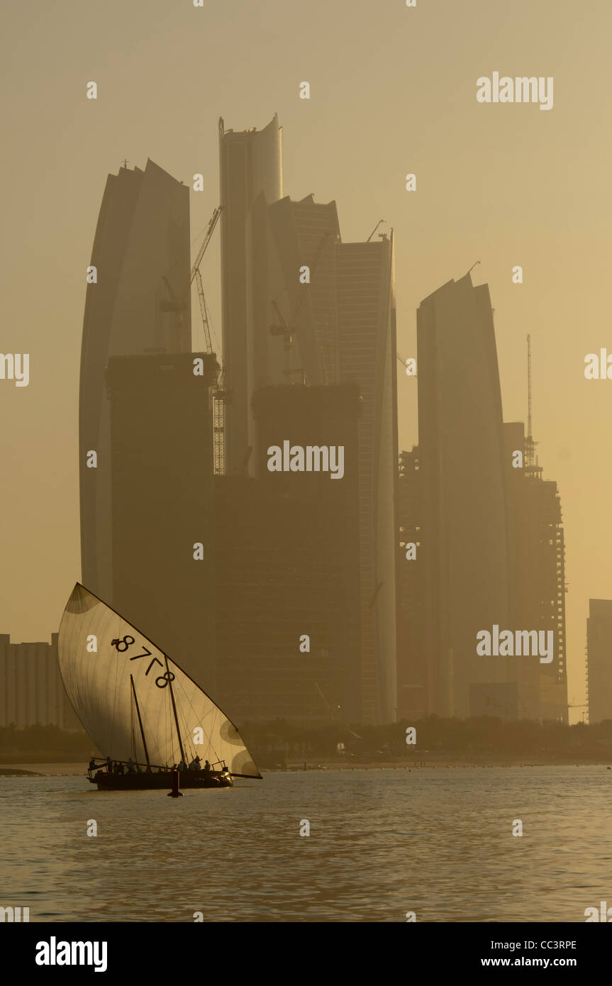 A sailing Dhow against a background of sky scrapers Stock Photo