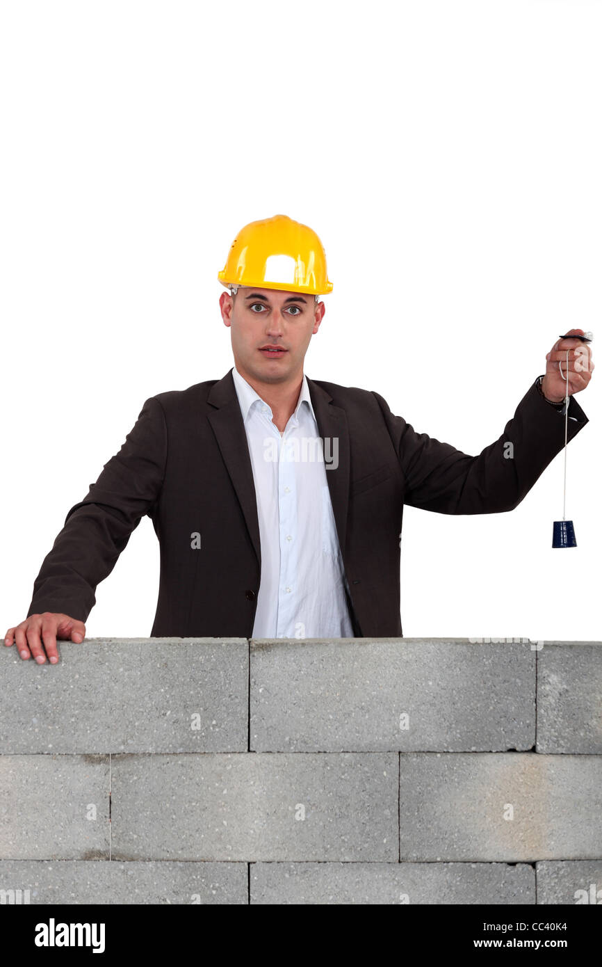 Builder using a plumb line Stock Photo Alamy