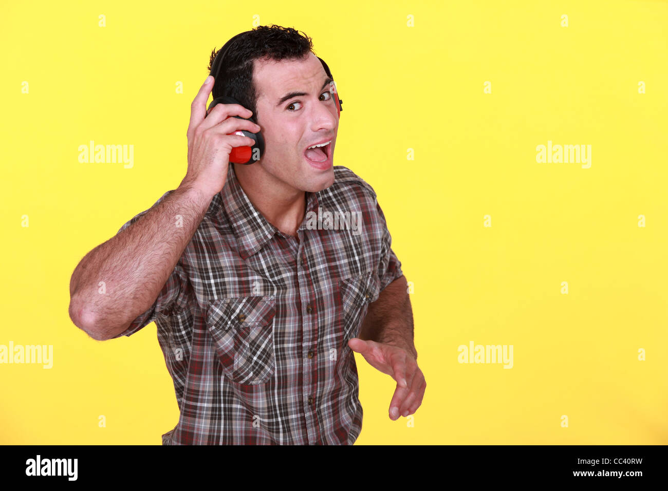 Man wearing ear defenders Stock Photo Alamy