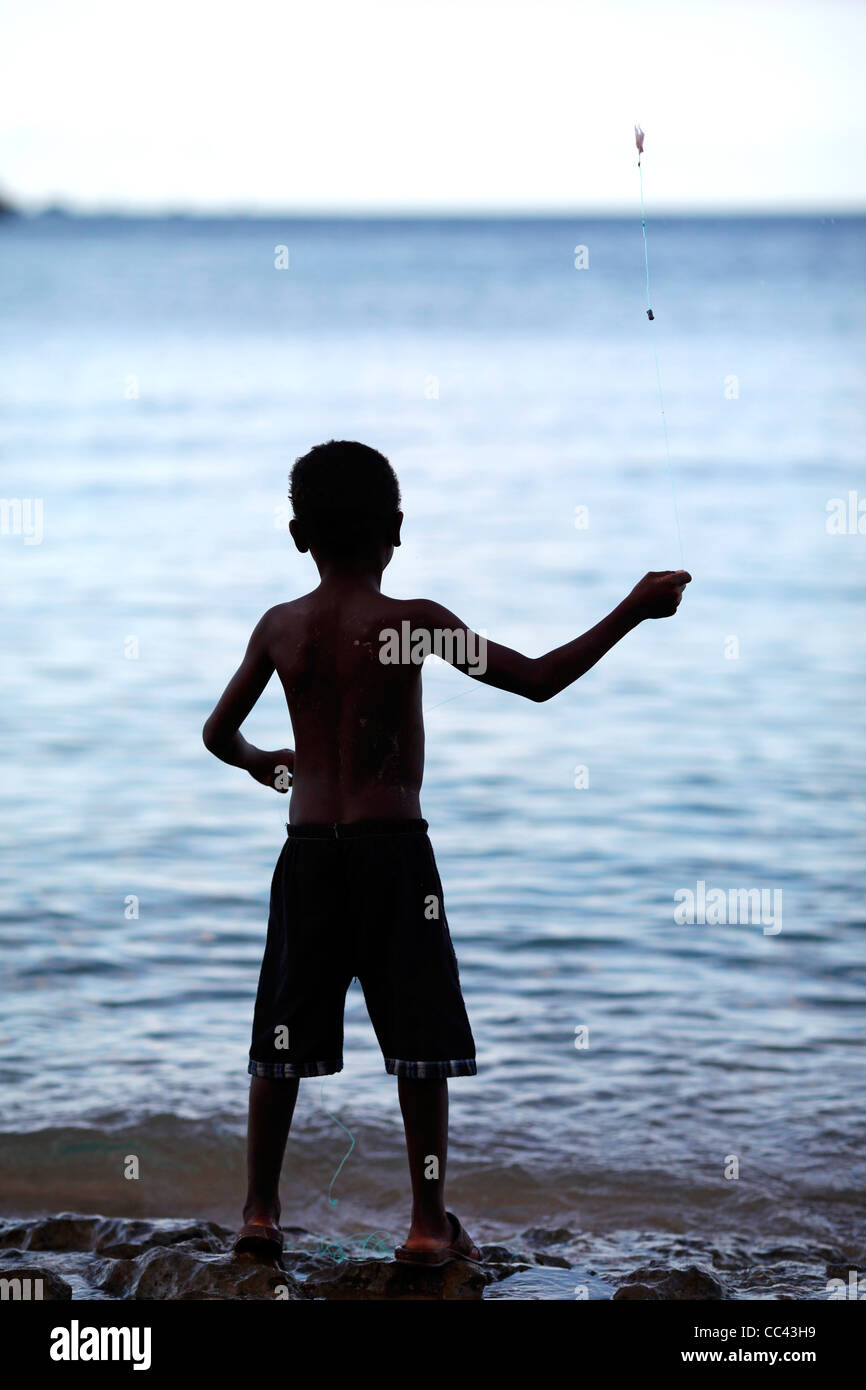 A young malagasy boy fishing, throwing a line with bait in Stock ...