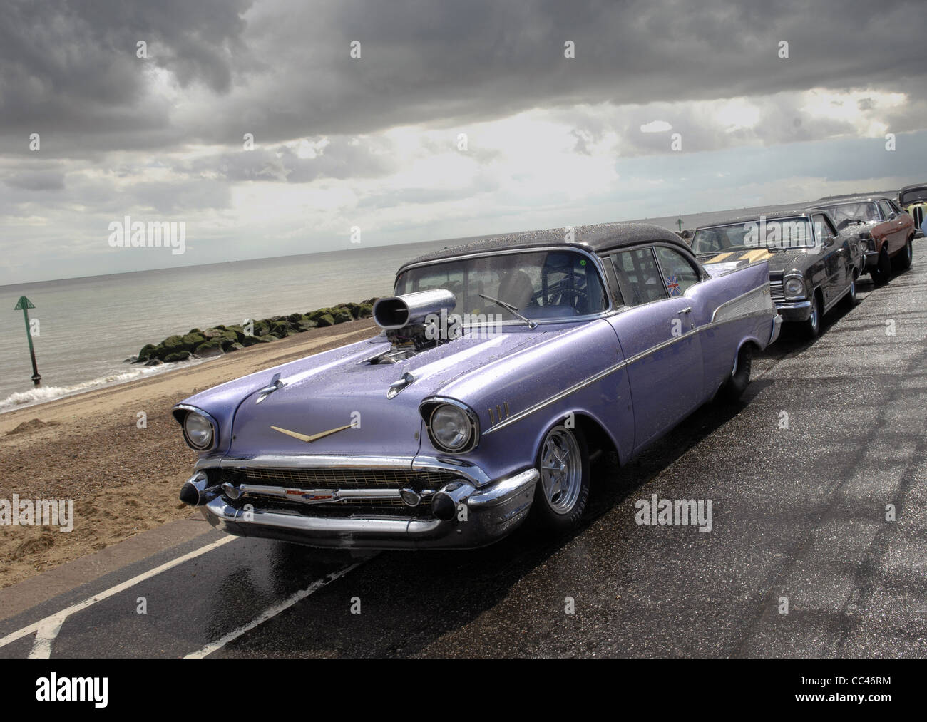 Stunning modified Chevy Bel Air on the seafront at Felixtowe during the 2011 NASC rally. Moody skies after a thundery shower. Stock Photo
