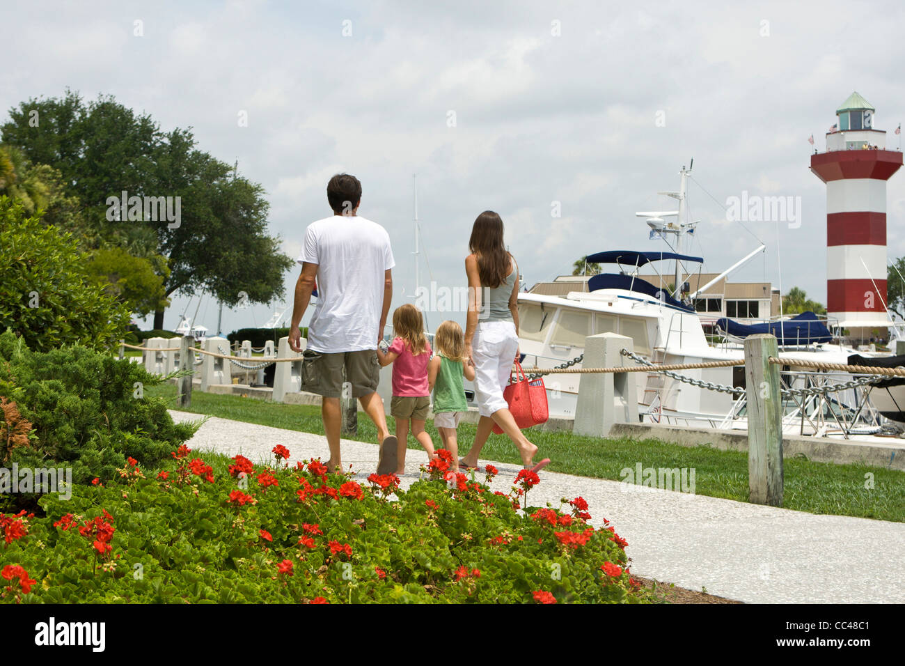 Parents and daughters (ages 4 and 5) walking to the marina to go