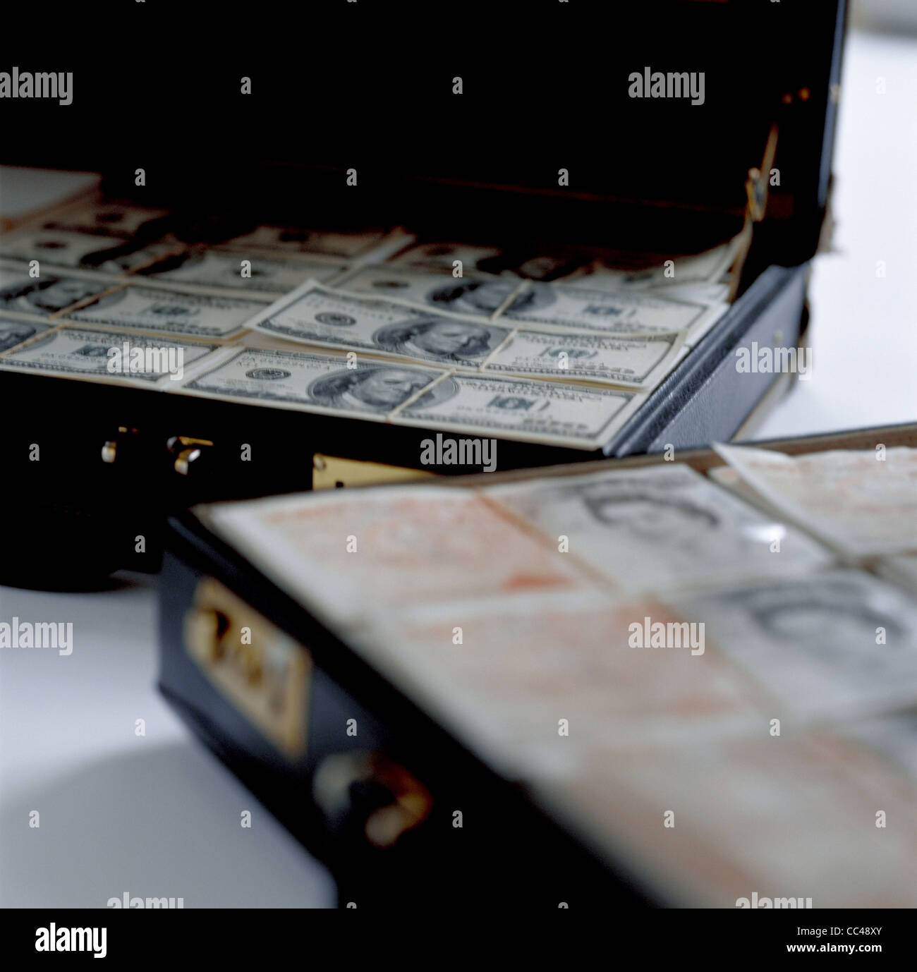 Briefcases full of dollars and sterling Stock Photo - Alamy