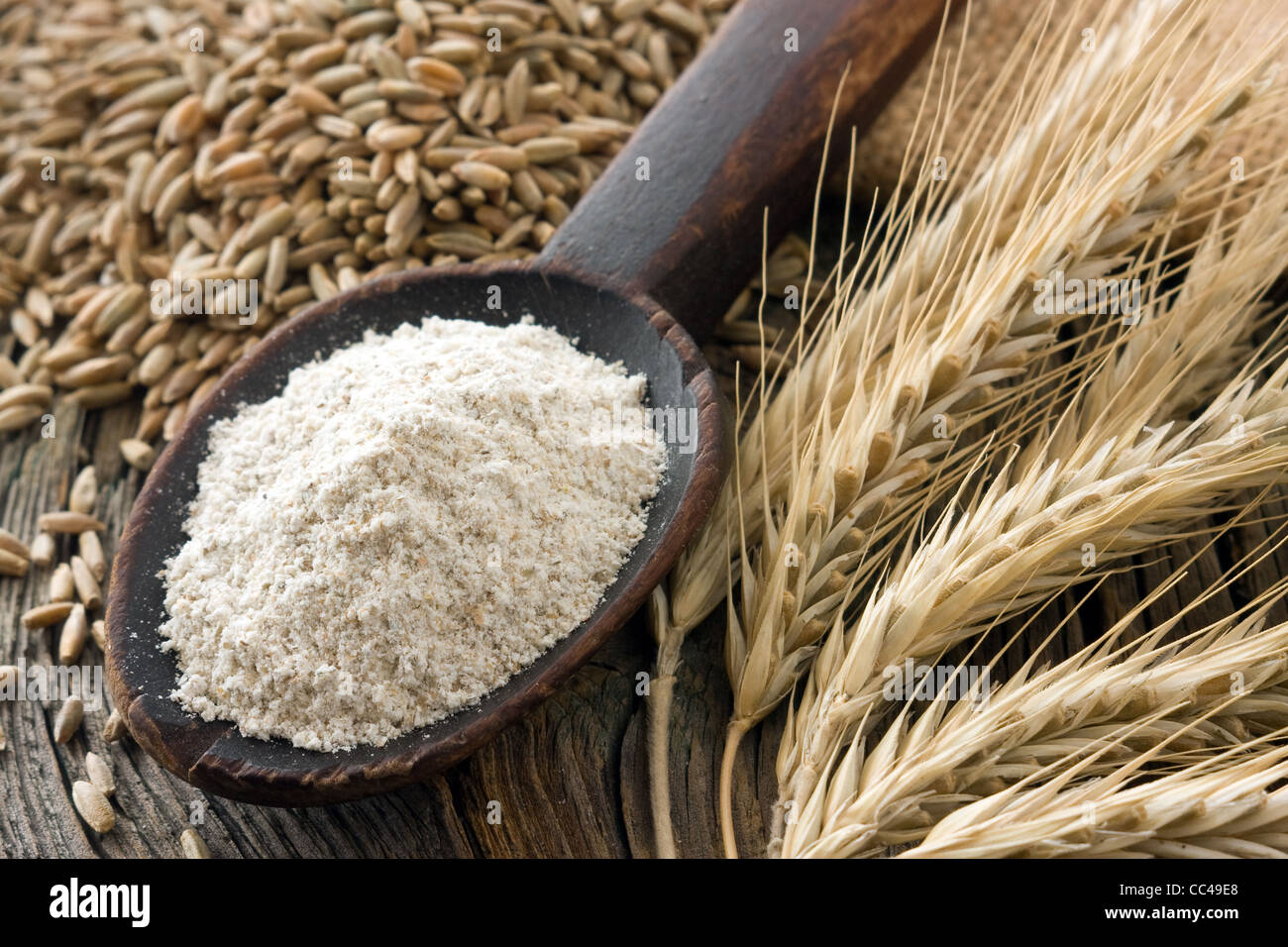 Flour wholemeal on old wooden spoon and rye ears Stock Photo Alamy
