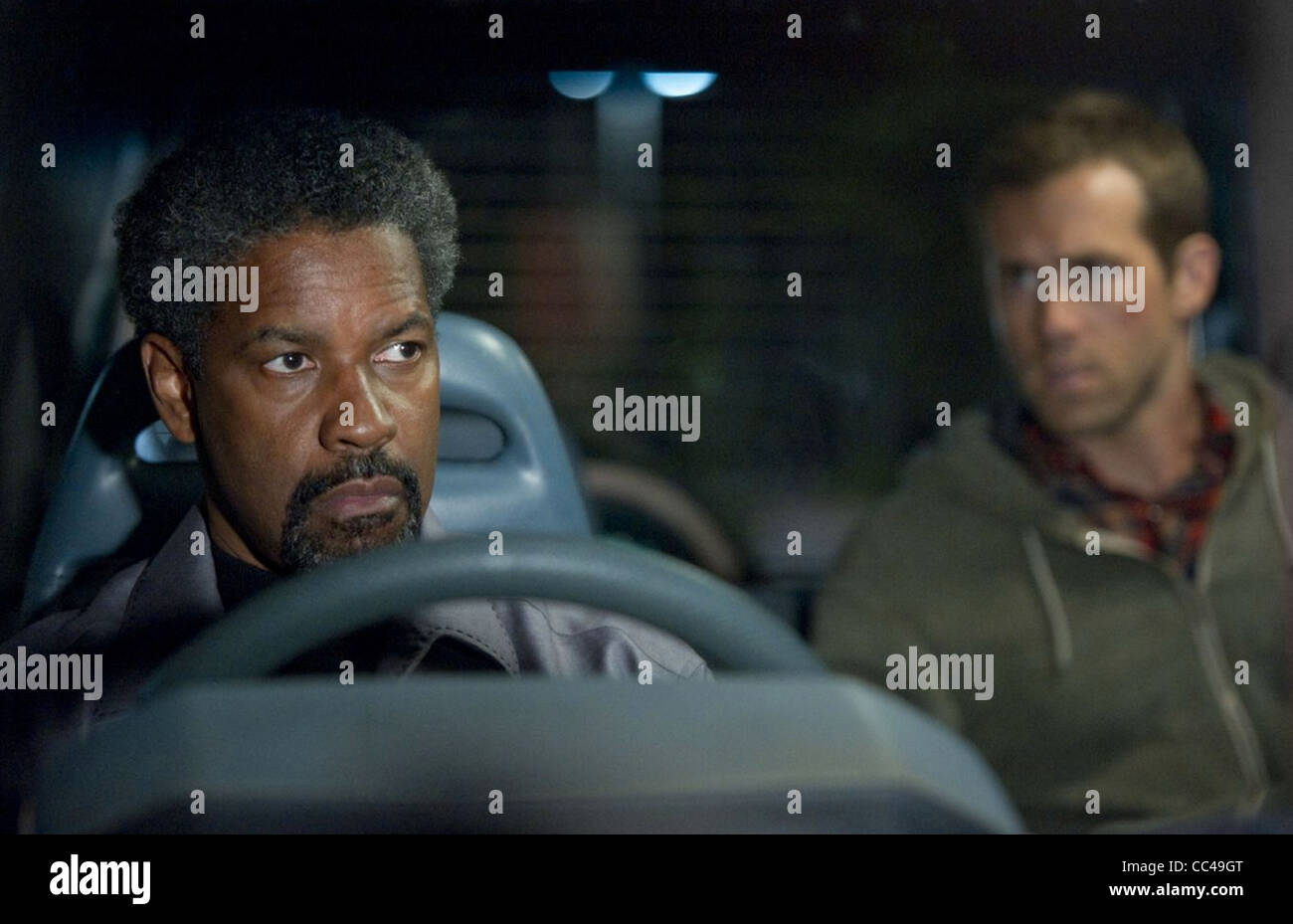 SAFE HOUSE 2012 Universal film with Denzel Washington at left and Ryan