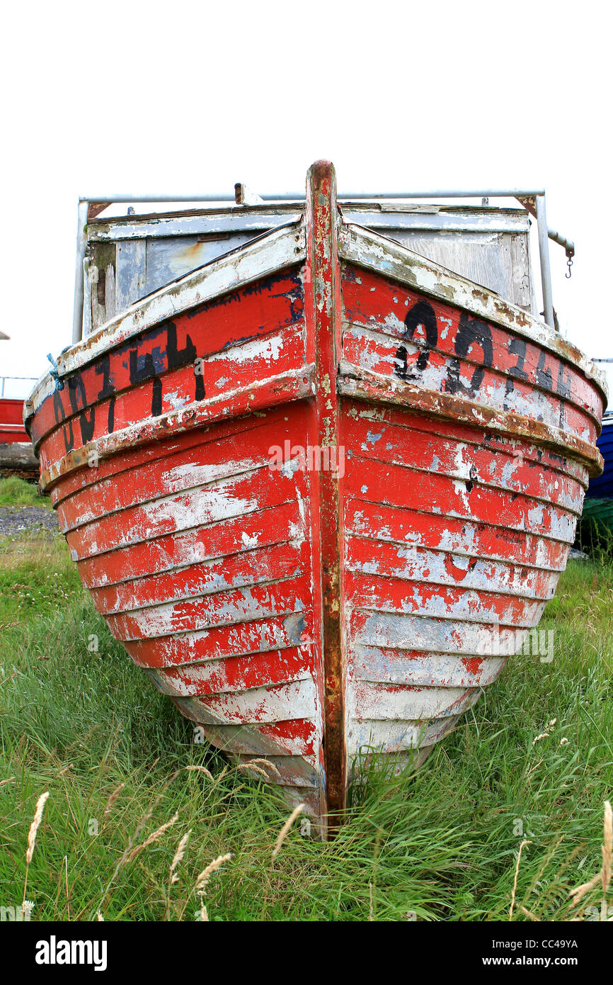 Old red weathered wooden fishing boat. Ireland Stock Photo