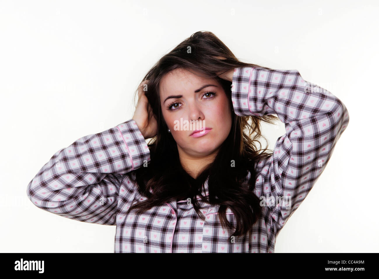 woman just got up wearing pajamas having a bad hair day Stock Photo