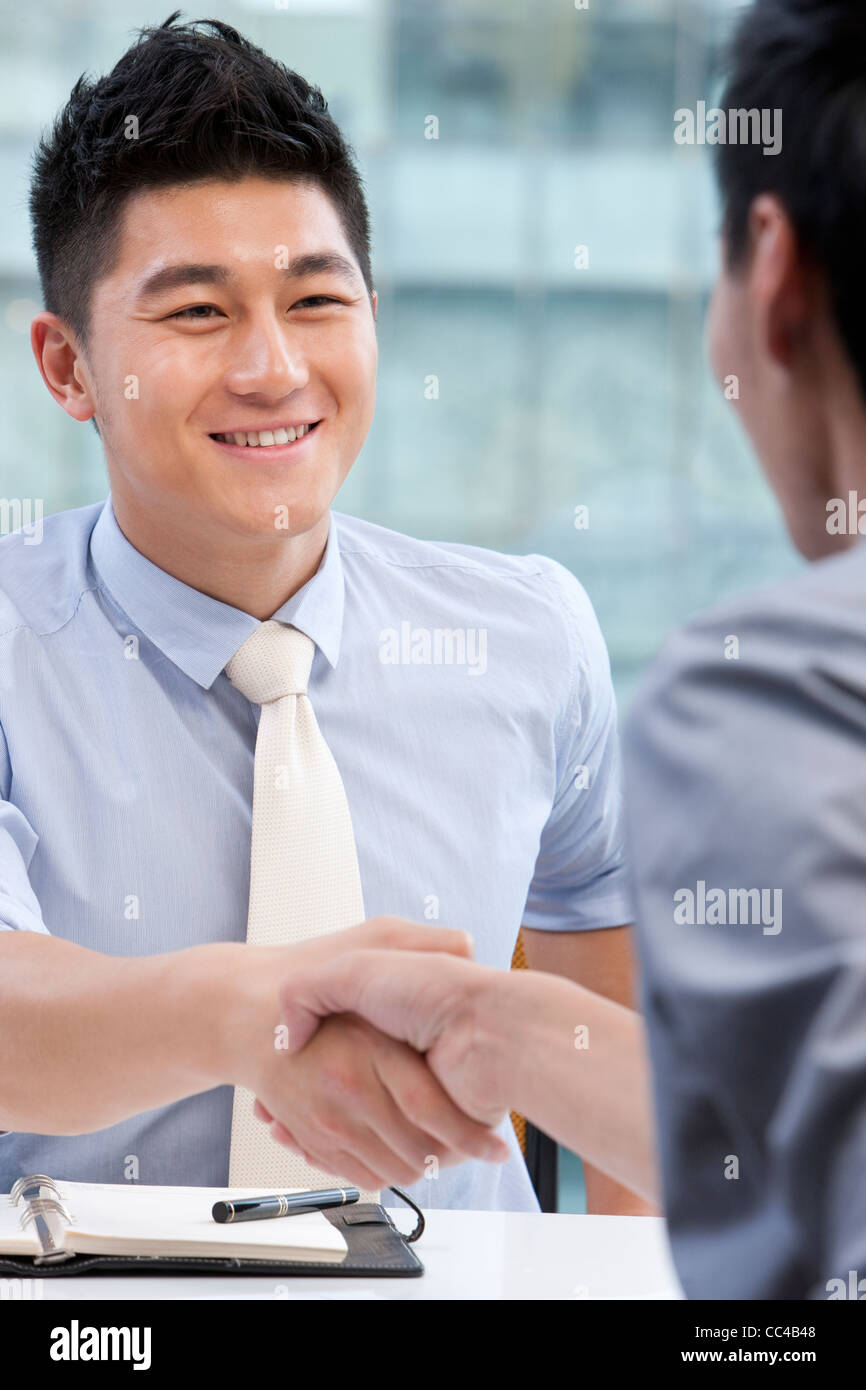 Businesspeople shaking hands Stock Photo Alamy