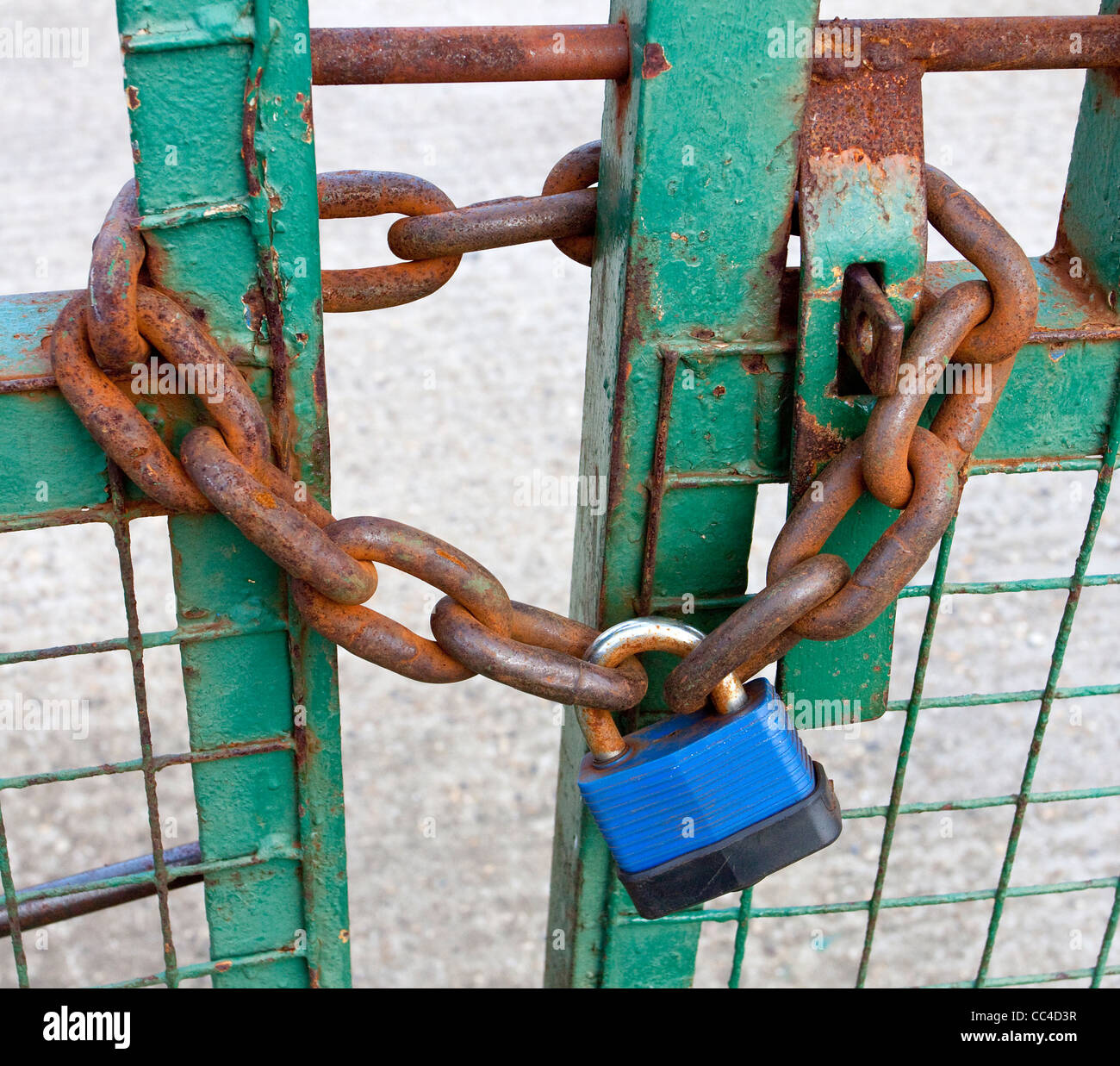padlocked gate industrial premises heavy duty padlock on gate Stock Photo