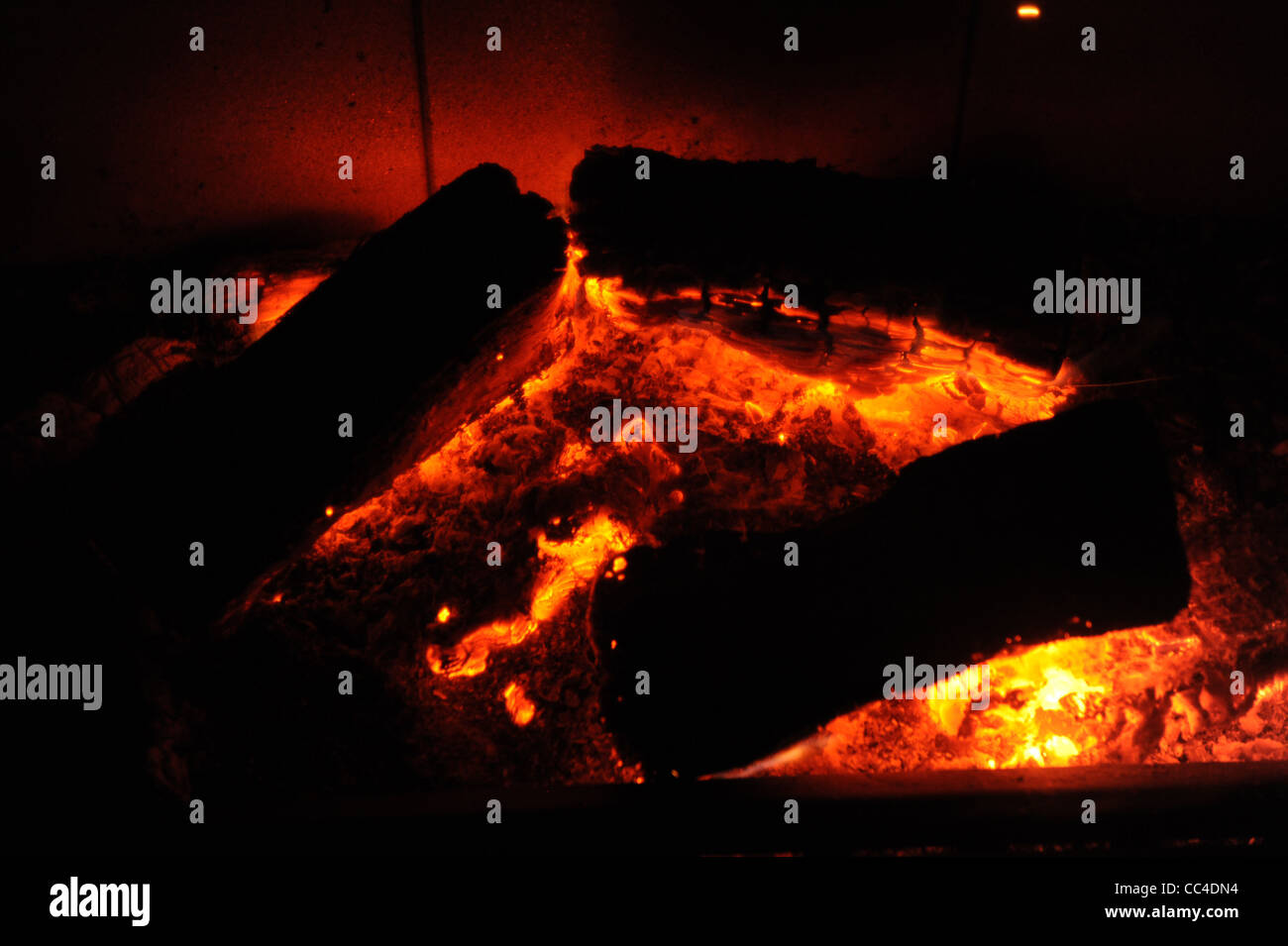 Logs burning on wood burner fire Stock Photo - Alamy