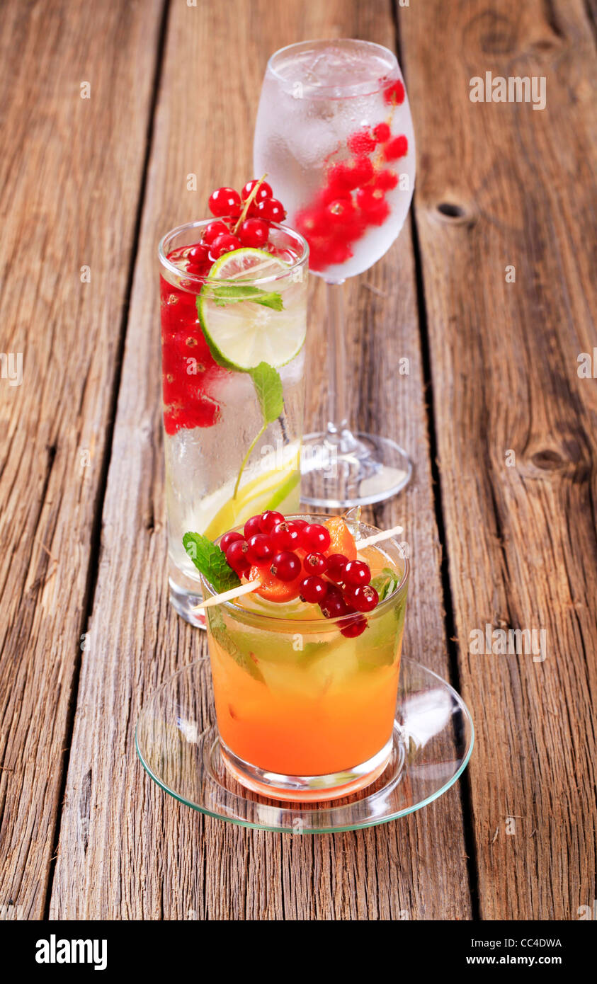 Glasses of iced drinks garnished with fresh fruit Stock Photo