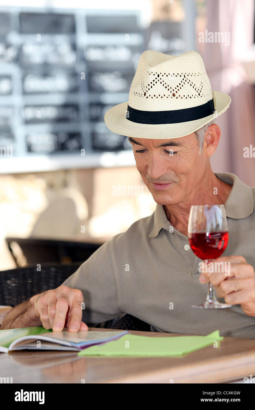 Elderly man drinking a glass of rosé in a café Stock Photo Alamy