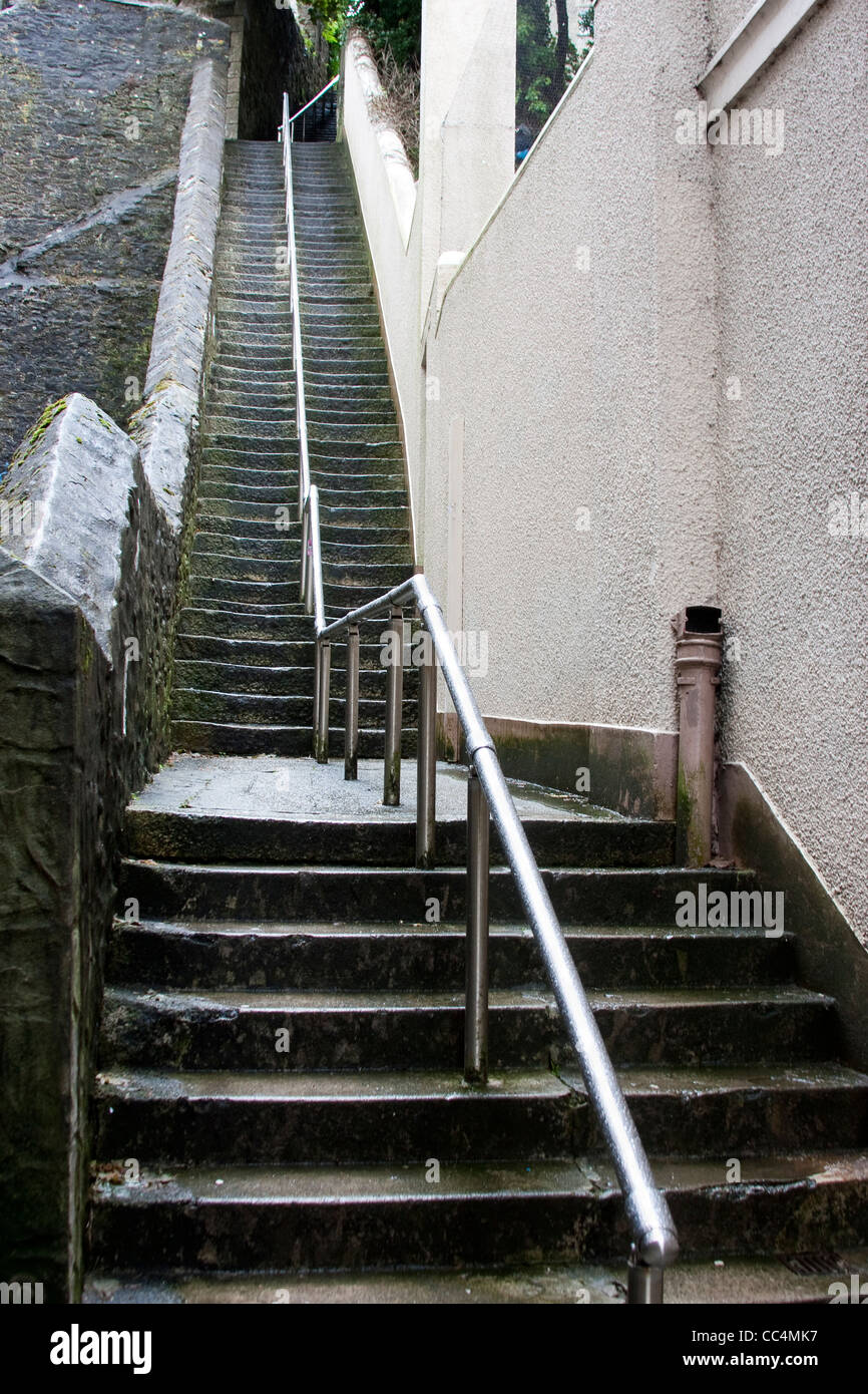 Abstract Tall Slippery Stone Steps with Shiny Steel Hand Rail Stock
