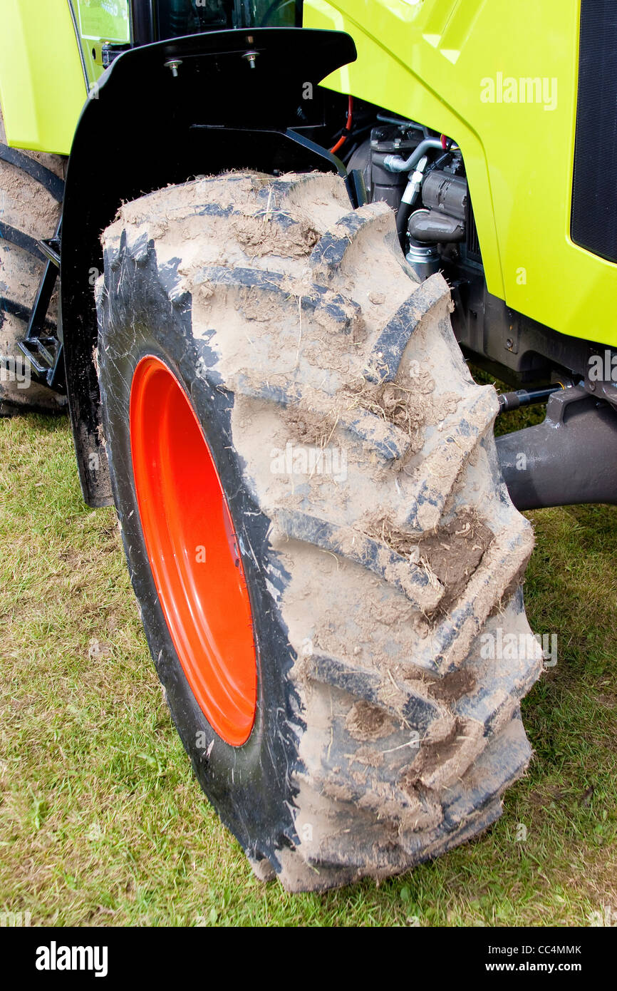 Agricultural Four Wheel Drive Tractor Detail of Red Wheel with Vibrant Green Body Stock Photo