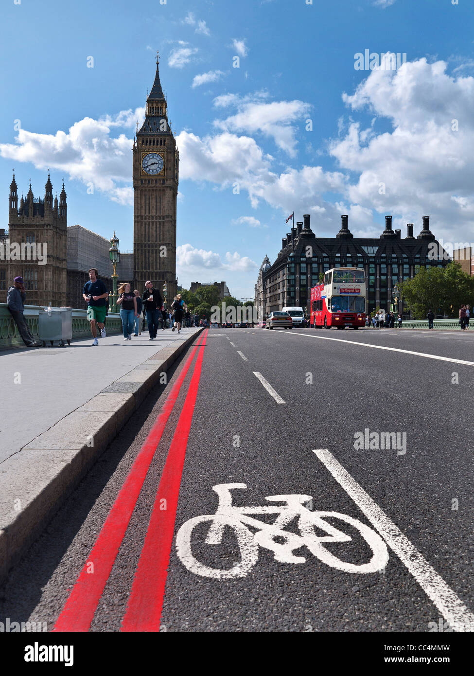 Bicycle lane and red route in Westminster  with Big Ben and Houses of Parliament London UK Stock Photo