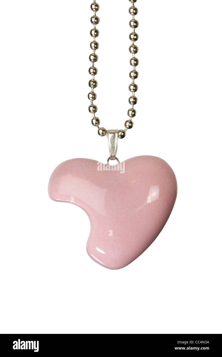 Pink heart shaped jewelery / jewellery with shinny enamel glaze on a cord, isolated against white background. Stock Photo