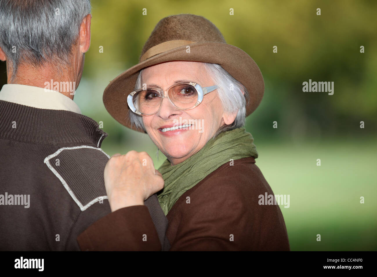 Woman with her arm on her husband's shoulder Stock Photo